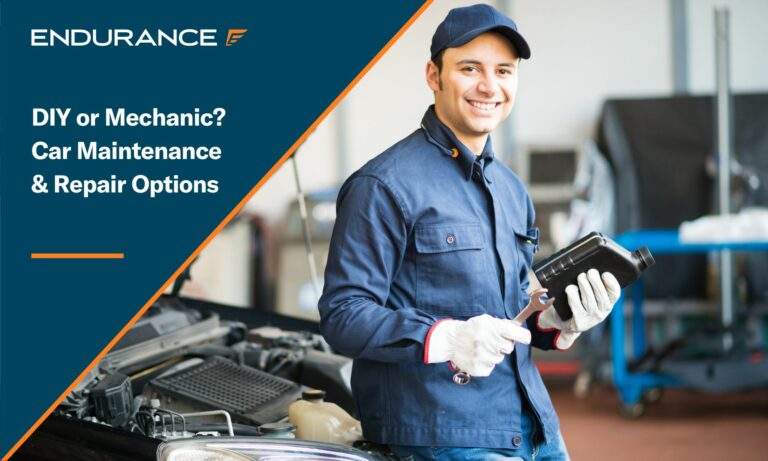 Auto mechanic holding a jug of motor oil