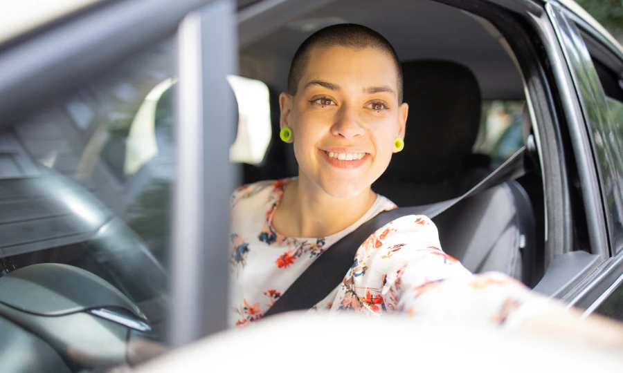 Woman is driving a car on her way to the mechanic