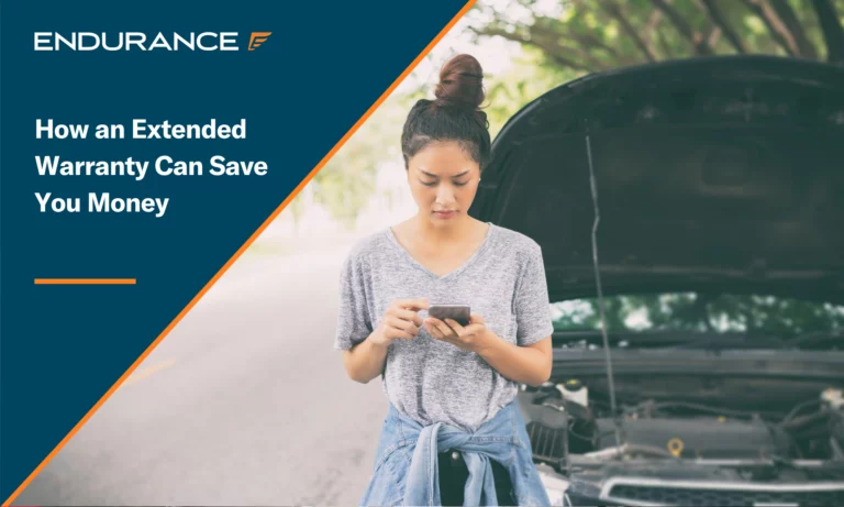 Woman using mobile phone while standing in front of broken down car