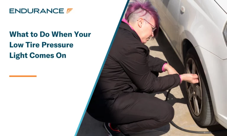 Close up of woman crouching on the gas station and inflating tire