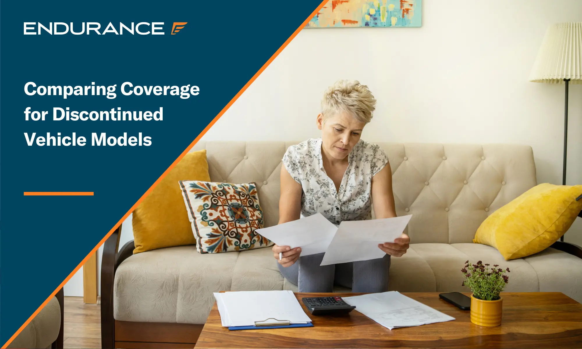 A woman looking at papers while sitting on the couch