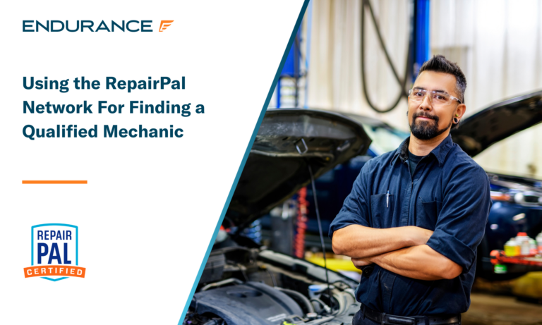 Mechanic in a uniform standing with his arms crossed in an auto shop