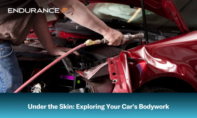 Auto body mechanic removing the side fender from a vehicle