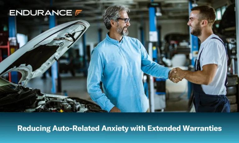 Satisfied customer shaking hands with auto mechanic in repair shop