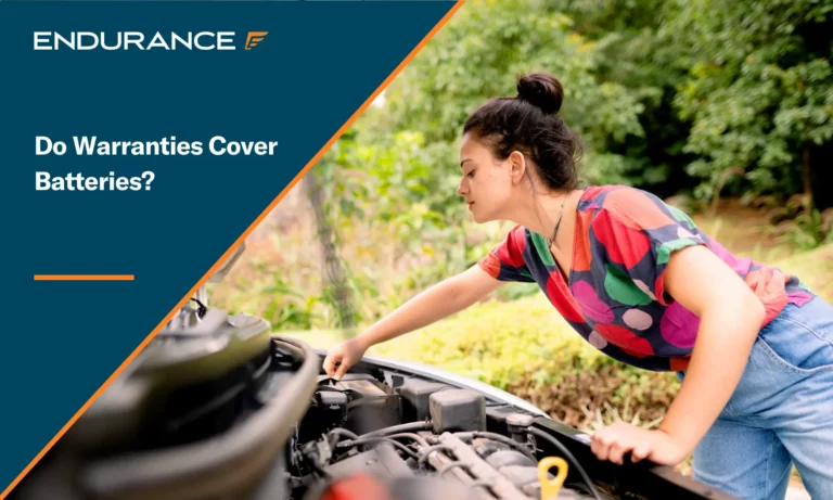Young woman checking her car battery connection under hood outside