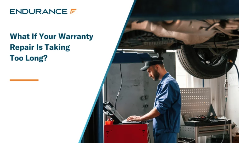 Auto mechanic working in a garage on a computer