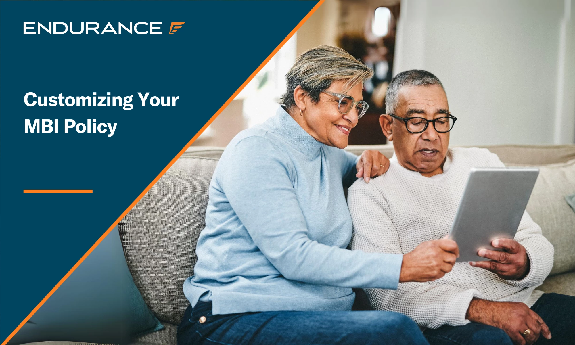 A senior couple using a tablet on their couch at home