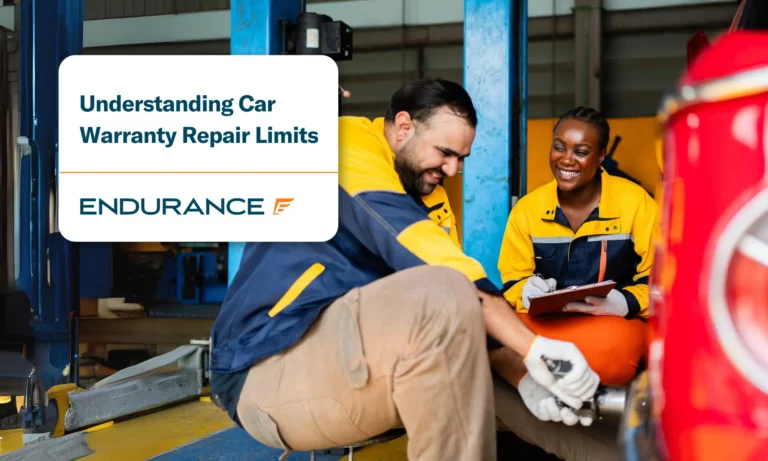 An male mechanic changing a tire and a female mechanic with a clipboard