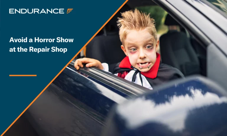A little boy on Halloween dressed up as a vampire looking in car mirror