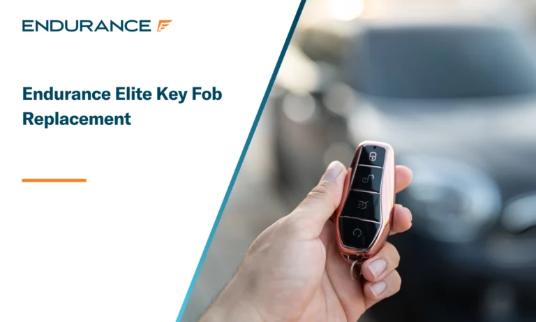 A driver's hand holding a keyless key fob to unlock the car