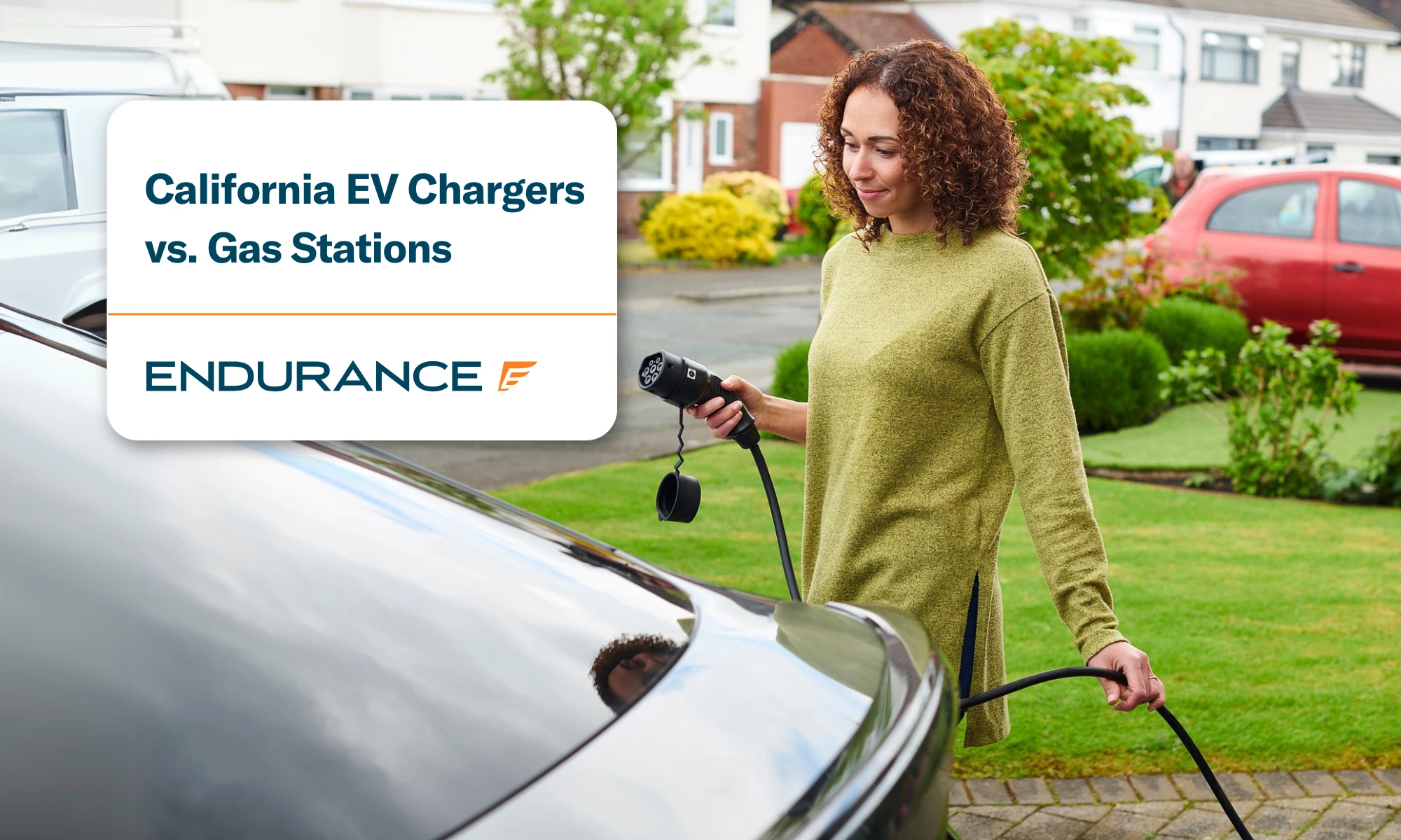 A woman using an electric car charger at home