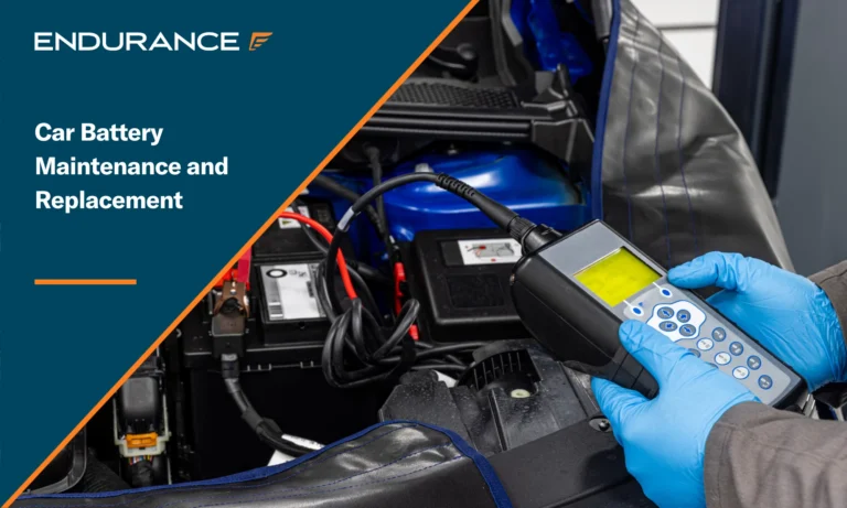Mechanic checking a car battery with a digital electronic battery tester