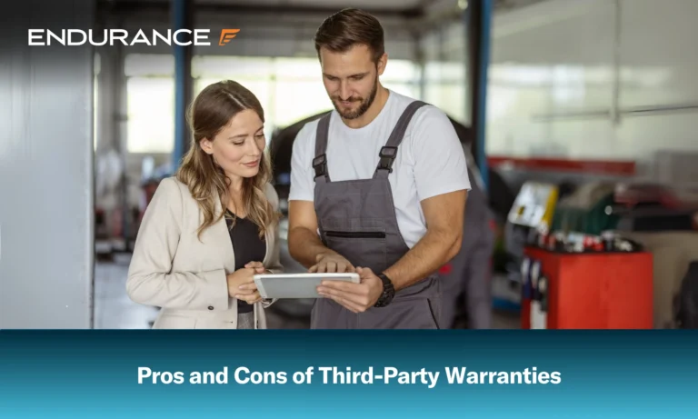 A mechanic and a businesswoman looking at a digital tablet at a service garage