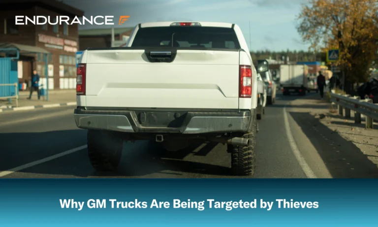 A white GM truck in a line of traffic on the road