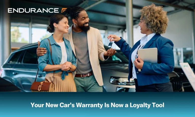 Happy couple receiving keys of their new car from saleswoman