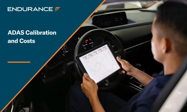 Mechanic using a digital tablet while looking at car diagnostics