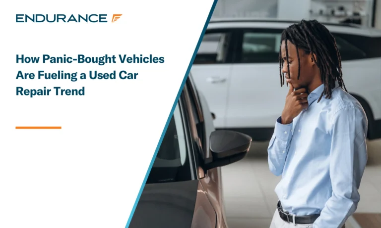 A car salesman looking at a used in car in a dealership