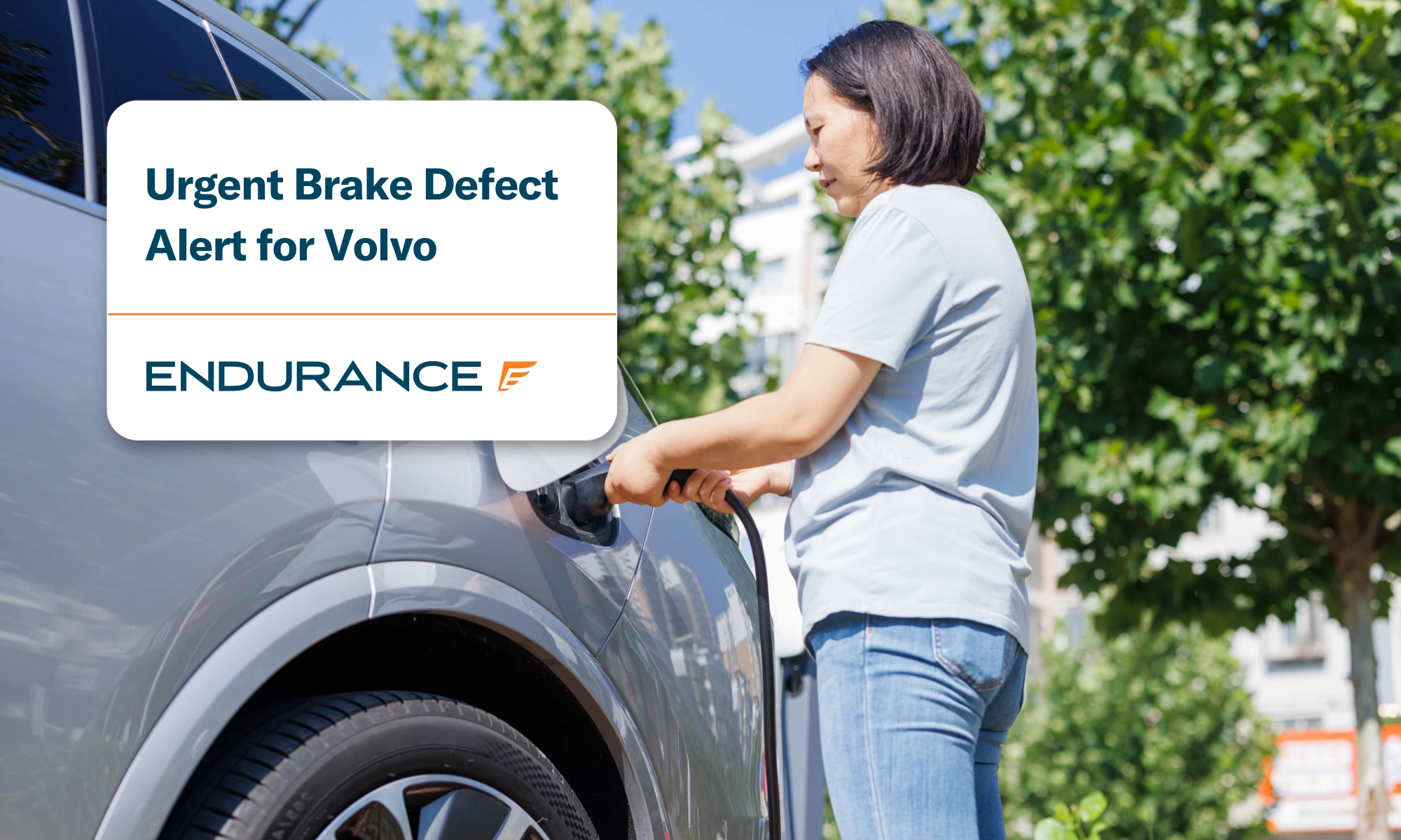 Women inserts a power cord into an electric car for charging