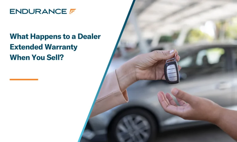Car saleswoman handing over car keys to a new owner
