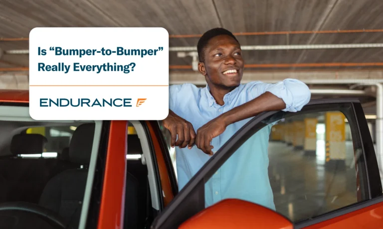 A happy man standing by the drivers side of his car with the door open