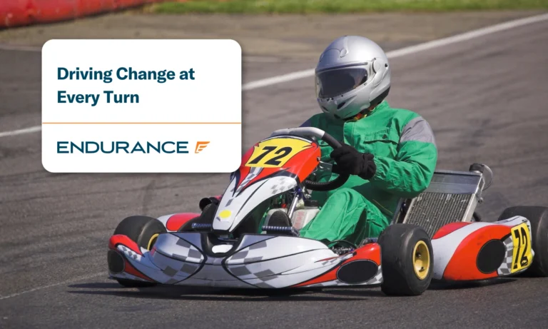 A go kart and driver racing round a track