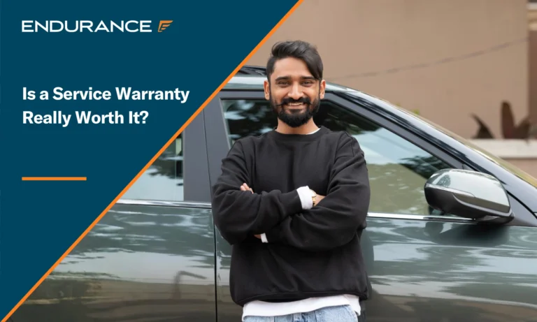 A man with his arms crossed leaning on a vehicle