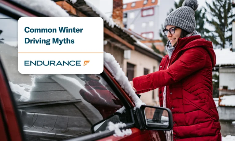 Woman outside in winter cleaning snow off her car