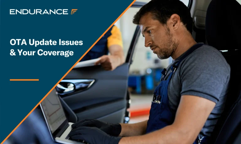Auto repairman testing car's performance on a computer