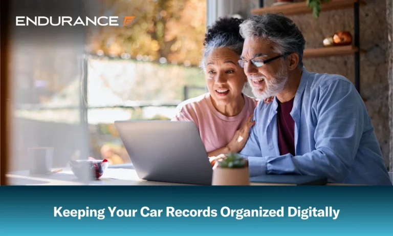 A senior couple looking at laptop at home, keeping your car records organized