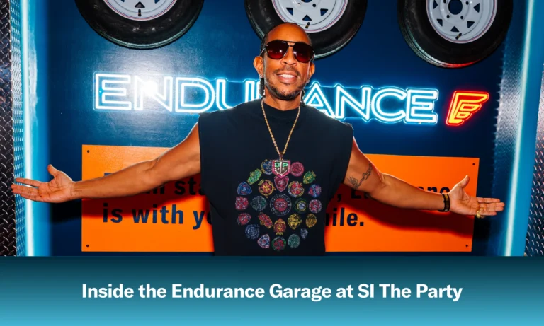Ludacris posing in front of an Endurance sign at SI The Party