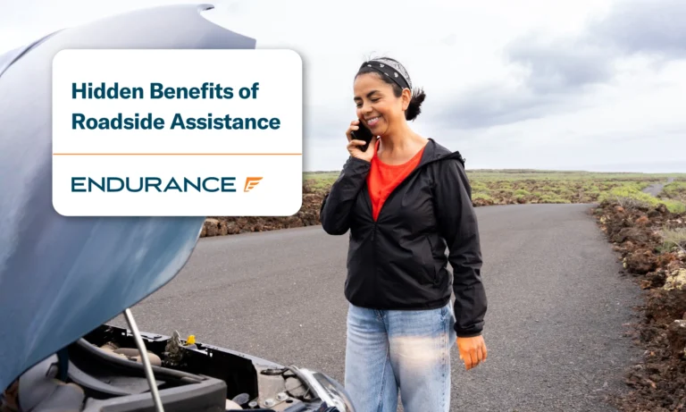 Woman standing on the side of the road calling roadside assistance