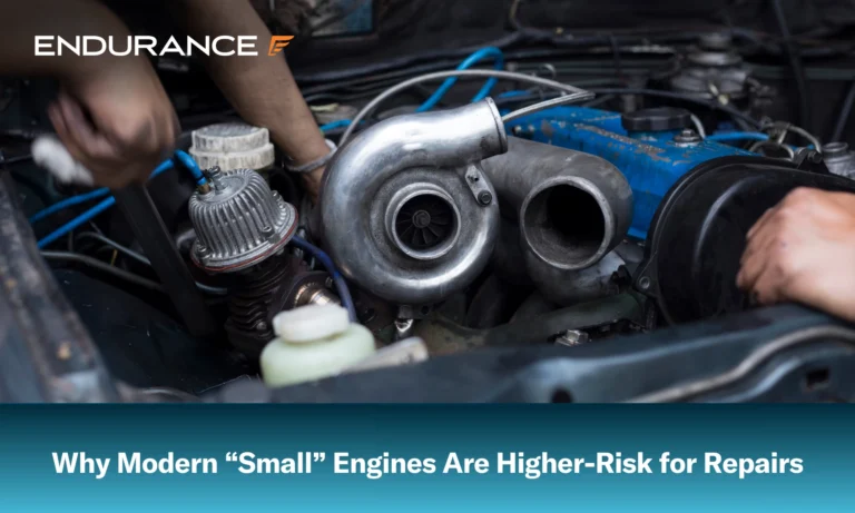 Mechanics working on the turbocharger of a vehicle's engine