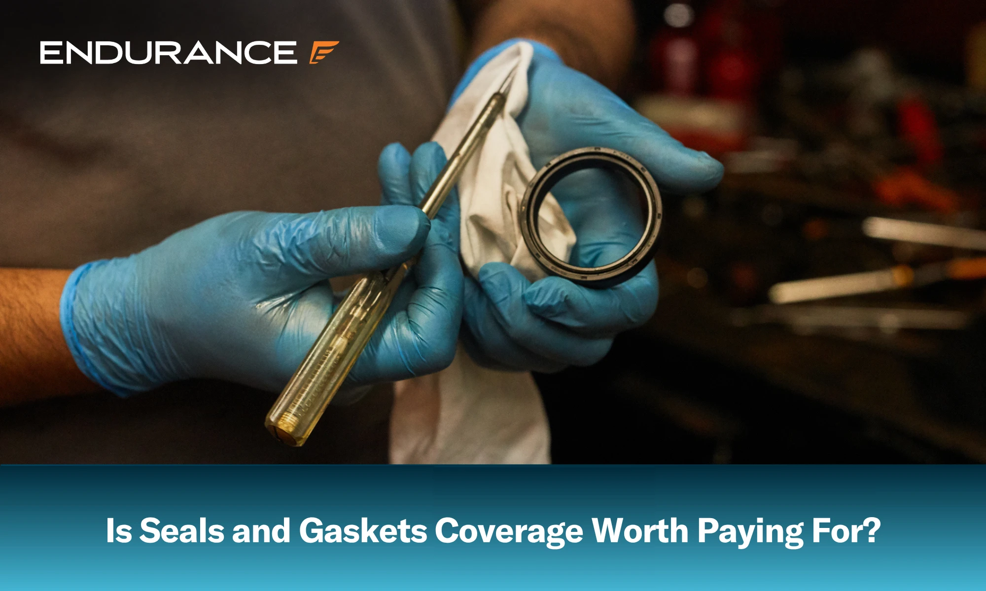 A mechanic holding a seal and gasket puller, is seals and gaskets coverage worth it