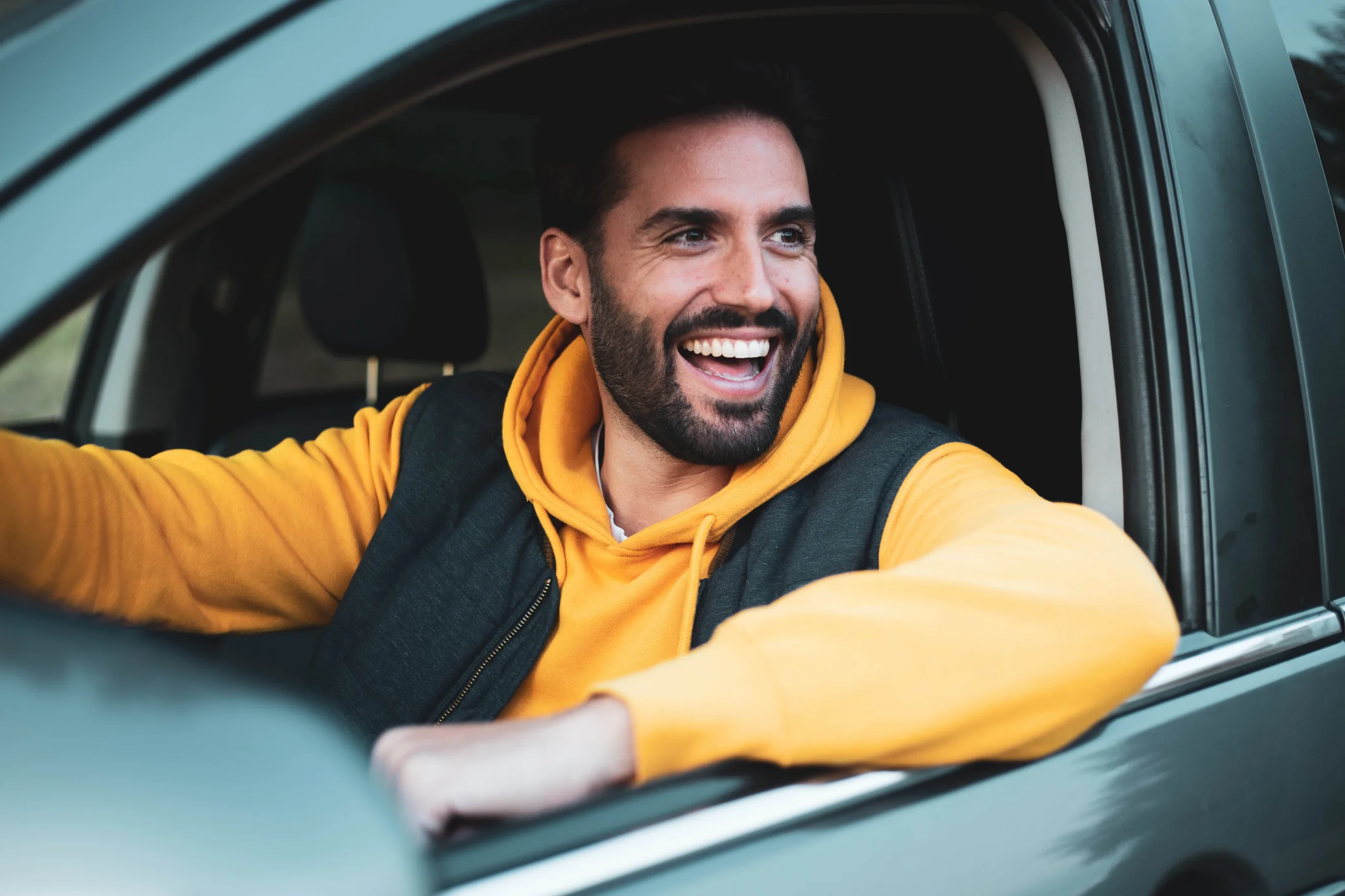 Man Smiling While Sitting Inside Of His Car