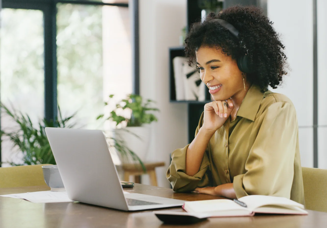 Young Woman with Headphones on Smiling at Computer