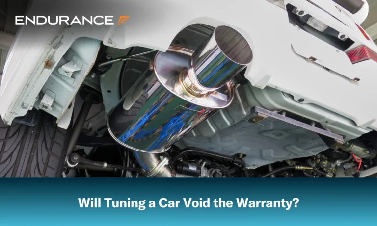 Close up of a lifted car muffler, will tuning your car void its warranty