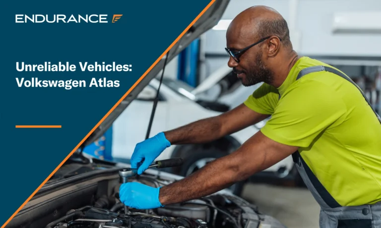 A mechanic repairs the engine of a car, Volkswagen Atlas reliability concerns