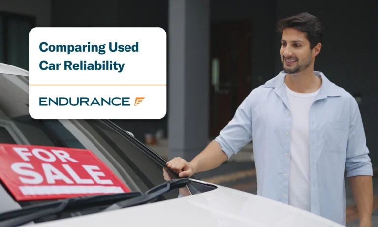 A young man looking at a used car for sale, comparing used car reliability